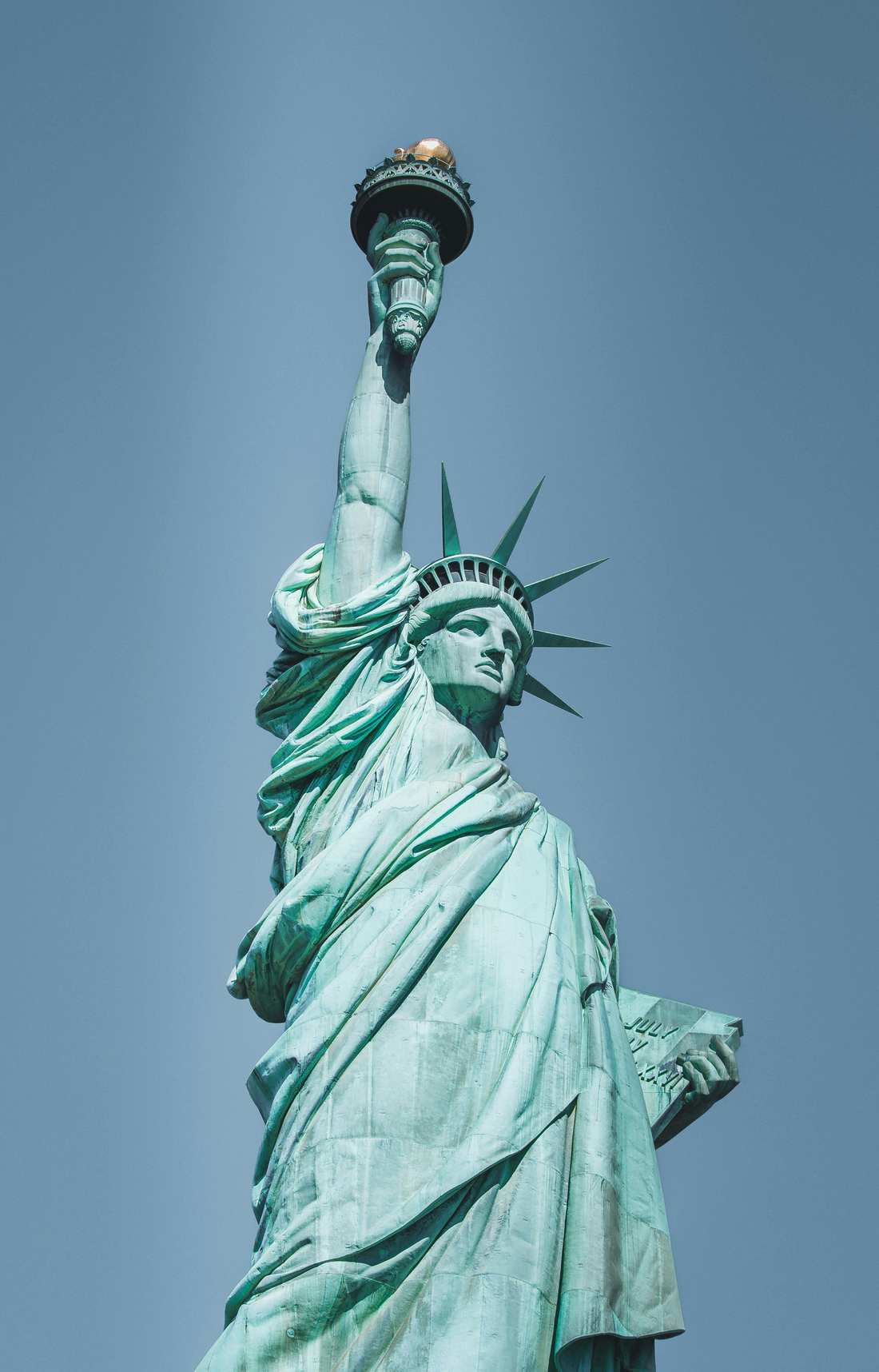 the statue of liberty against a clear blue sky