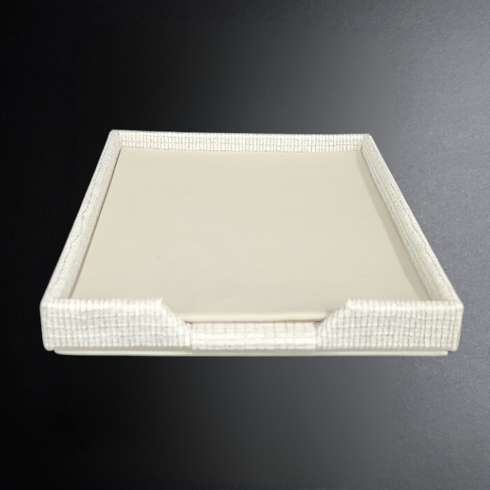 Rectangular tray with white interior and decorative border on a dark background