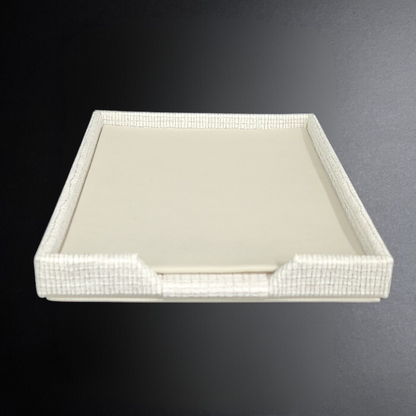 Rectangular tray with white interior and decorative border on a dark background