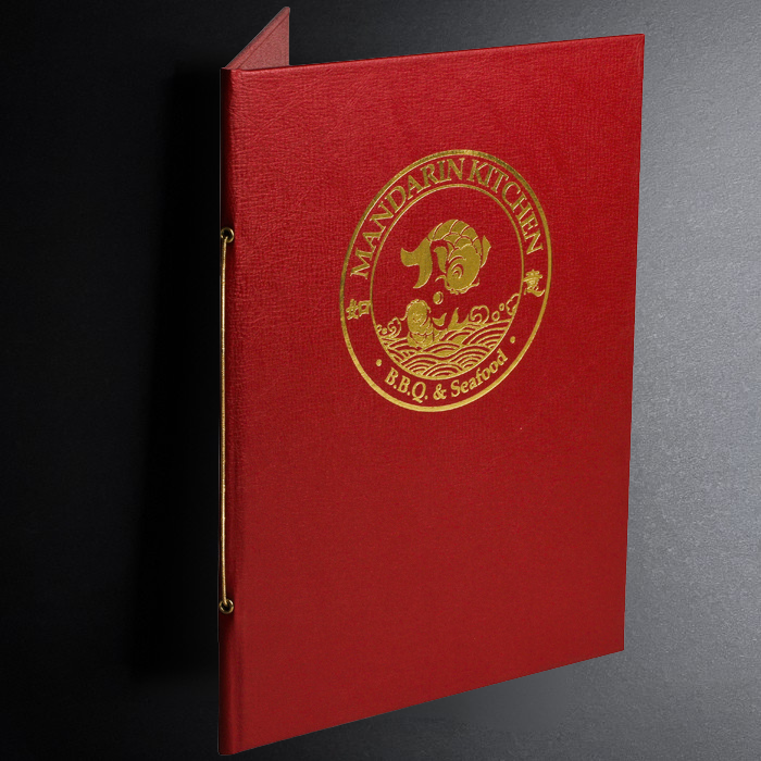 Red menu cover with gold embossed logo on a dark background