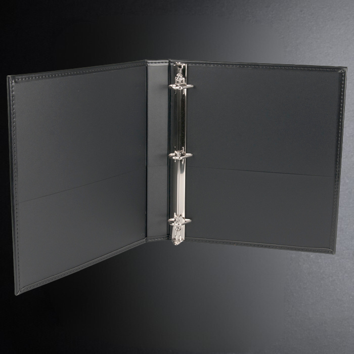 Black leather binder with a silver ring on a dark gray background