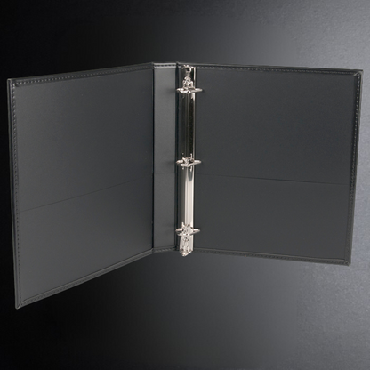 Black leather binder with a silver ring on a dark gray background