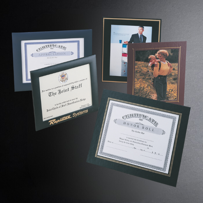 Framed certificates and a family photo on a dark background