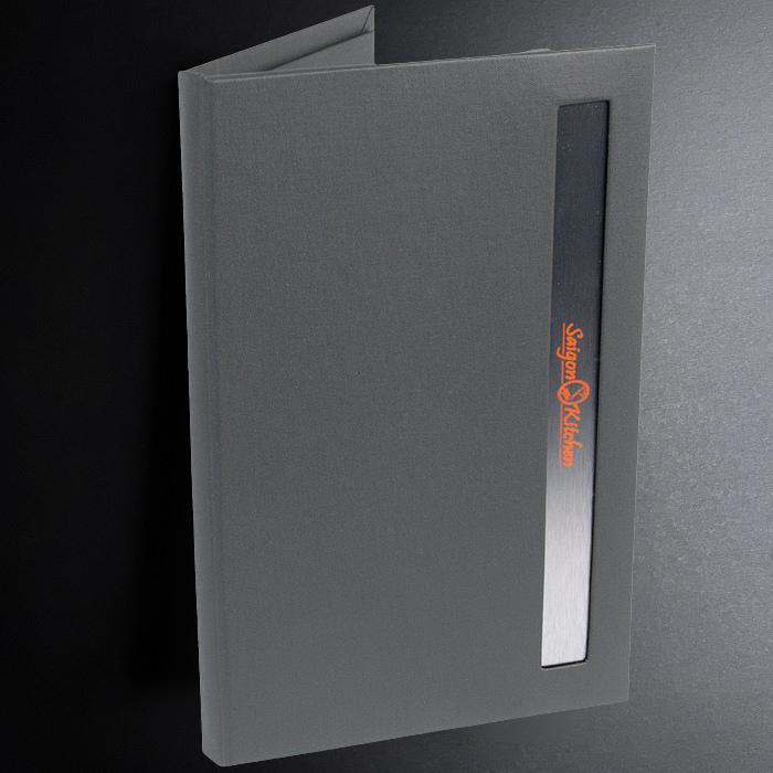 Gray menu cover with a logo on a dark background