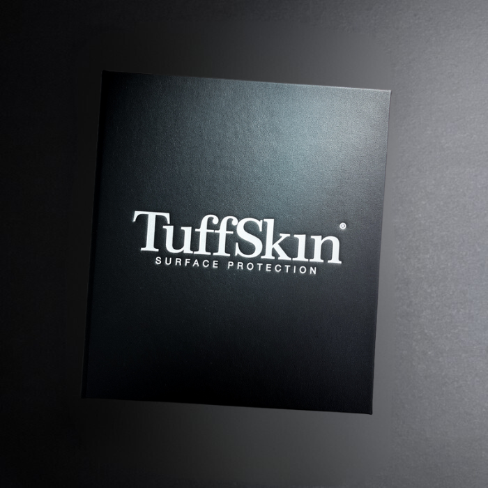 TuffSkin surface protection product packaging on a dark background