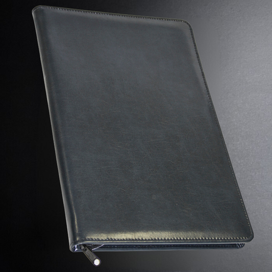 Black leather zippered notebook on a dark background