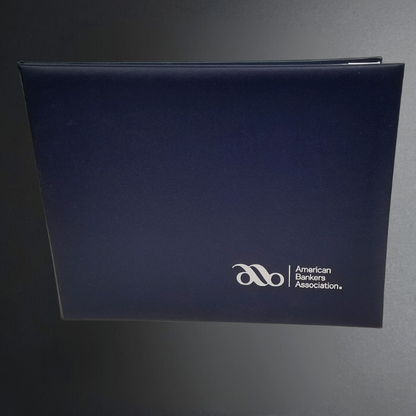 Blue binder with American Association of Advertising Agencies logo on a dark background