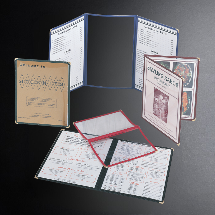 Collection of restaurant menus on a dark surface