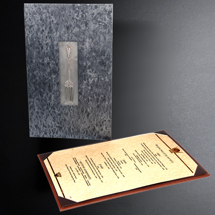 Menu with textured cover and detailed design on a dark background