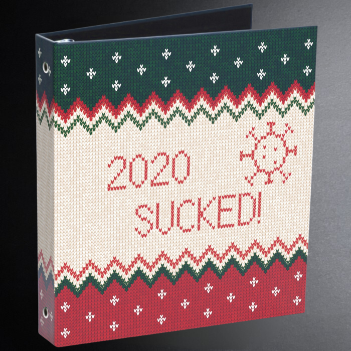 Decorative binder with '2020 SUCKED!' text and festive pattern on a gray background
