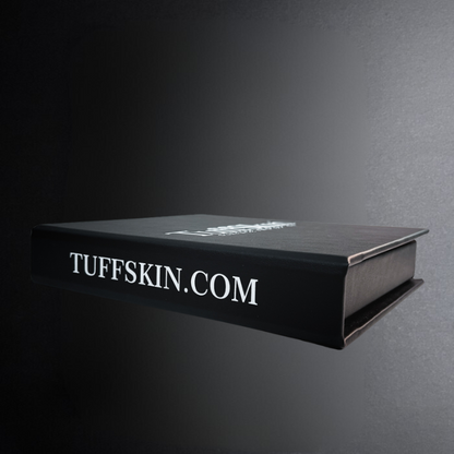 Black book with 'TUFFSKIN.COM' text on a dark background