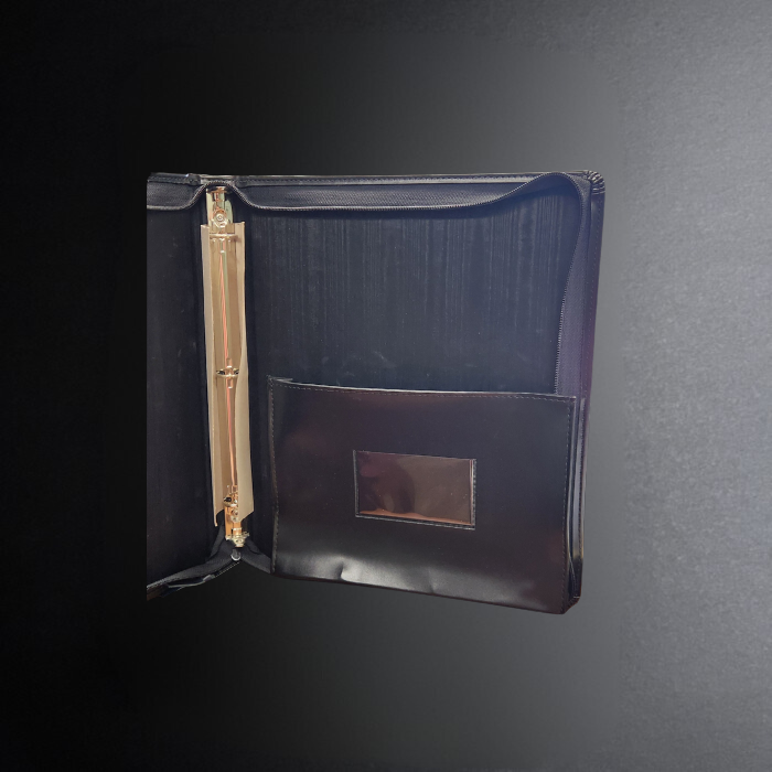 Black folder with a gold clip on a dark gray background