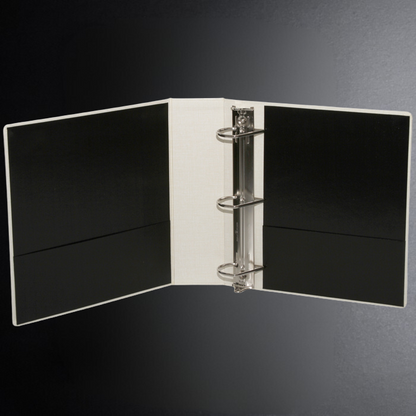 Open notebook with black pages on a dark gray background