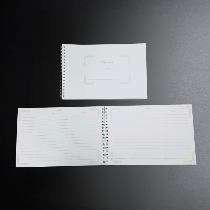 Open spiral-bound notebook with lined pages on a dark surface