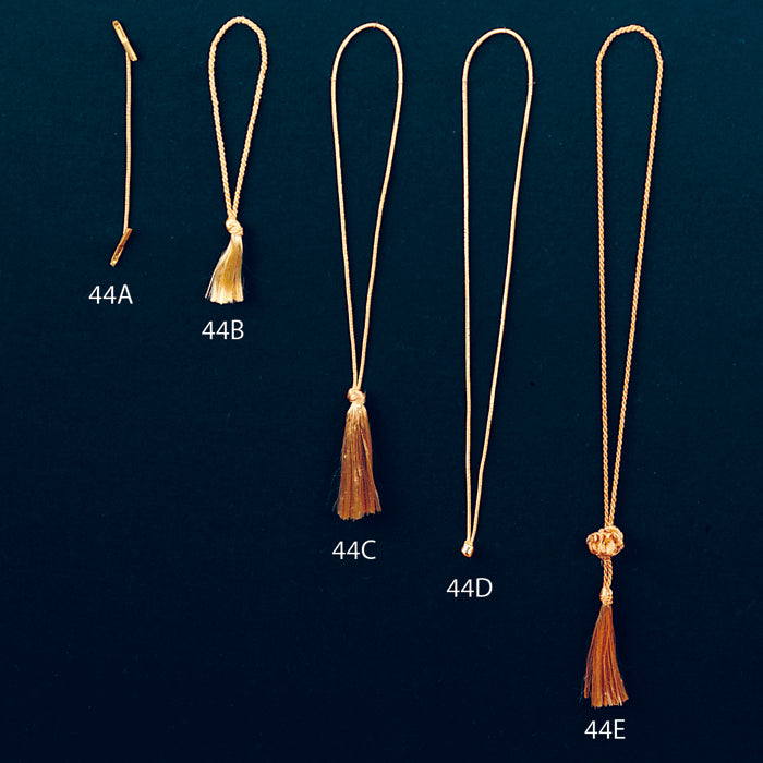 Set of five gold tassels labeled 44A to 44E on a dark green background