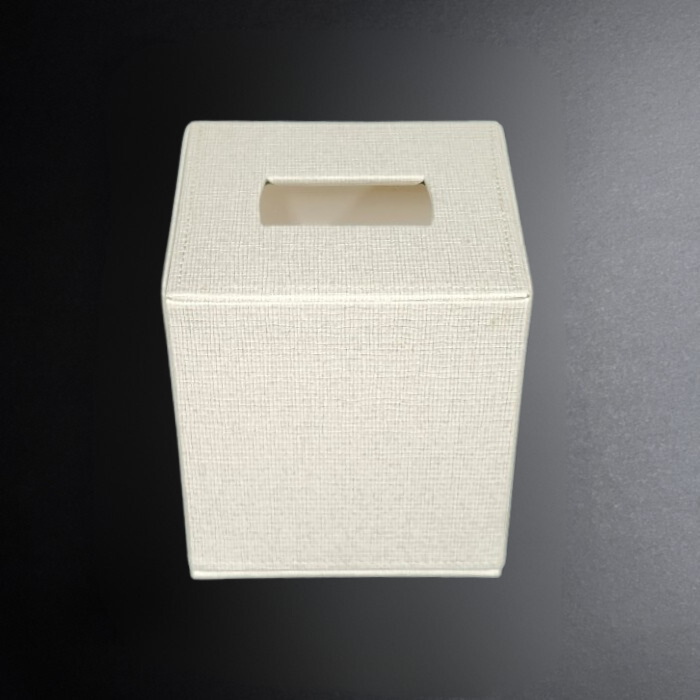 White textured square tissue box on a dark background