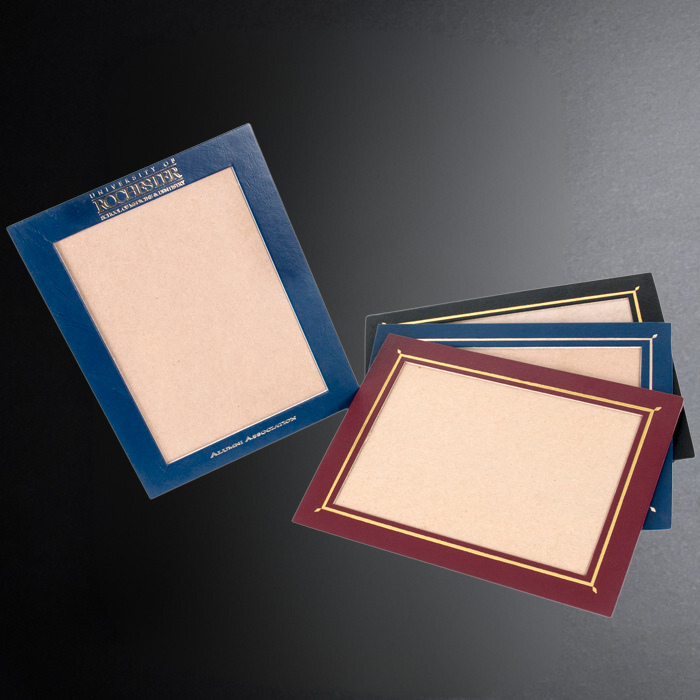 Two diploma frames with different color borders on a dark background