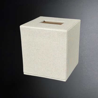 Beige textured square tissue box on a dark background