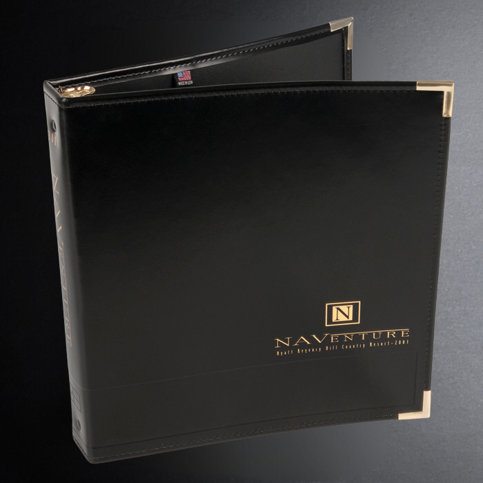 Black binder with gold accents and 'NAVENTURE' branding on a dark background