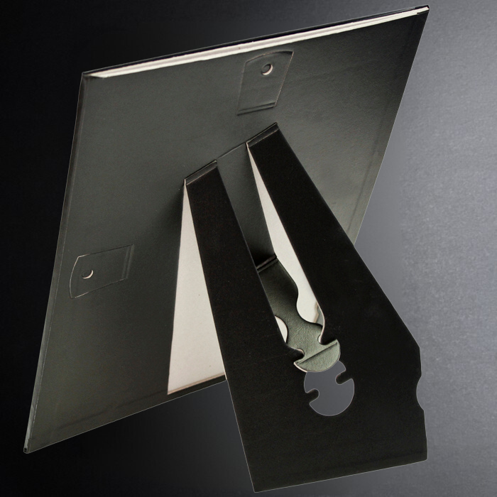 Metallic letter 'R' on a reflective surface with a dark background