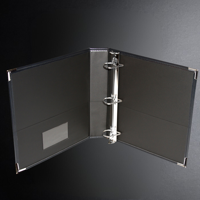 Black ring binder on a dark gray background