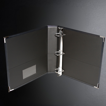 Black ring binder on a dark gray background