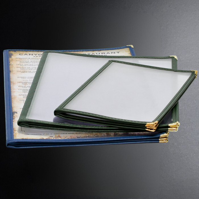 Two menu covers with gold clasps on a dark surface