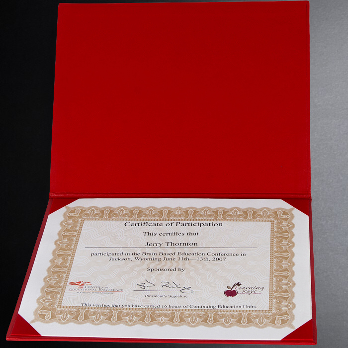 Certificate of Participation in a conference, enclosed in a red folder.