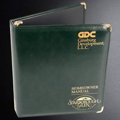 Green binder with 'GDC Ginsburg Development, L.L.C.' and 'Starborough Glen' branding on a black background