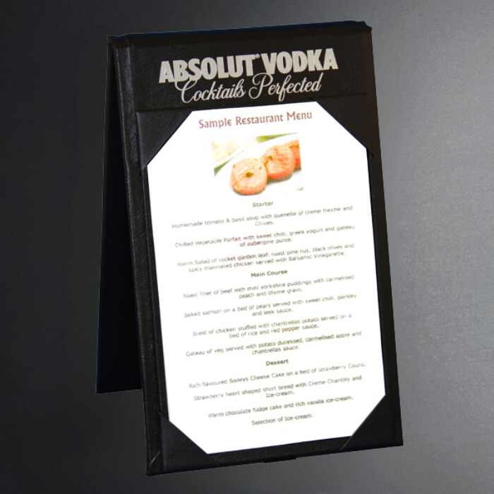 Absolut Vodka branded menu holder with a sample restaurant menu on a gray background