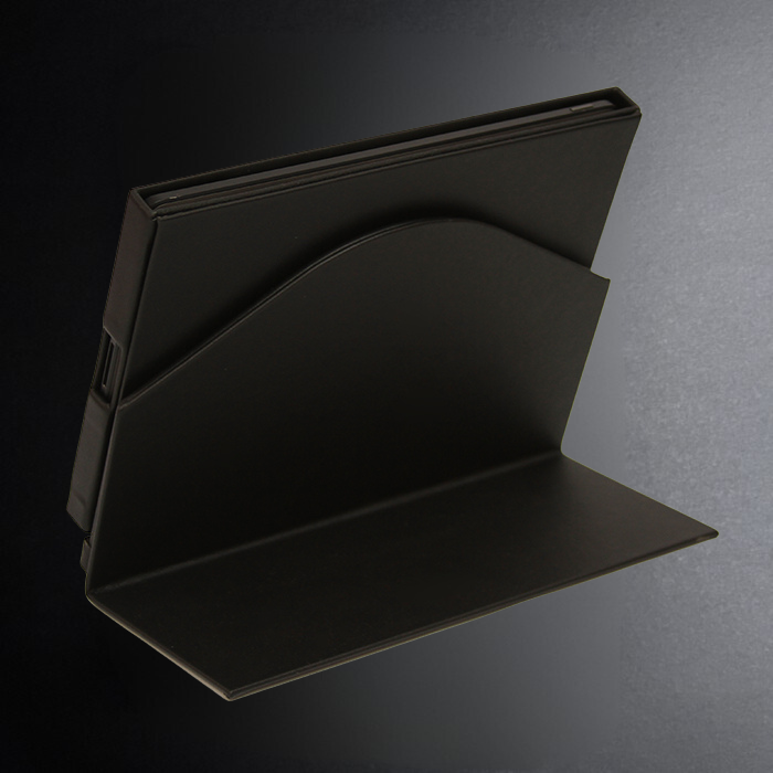 Black metal bookend on a dark background