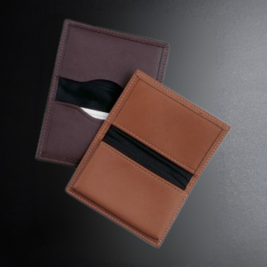 Brown leather cardholder with a black card on a dark background