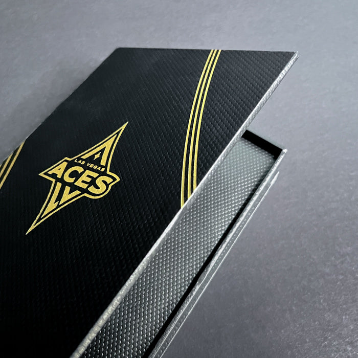 A black and gold cigar style box with 'Las Vegas Aces' logo on the cover.