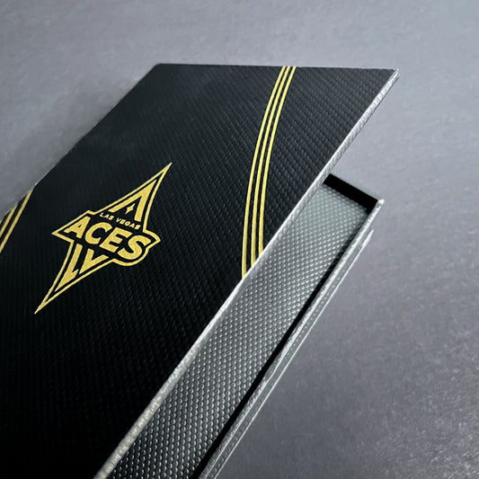 A black and gold cigar style box with 'Las Vegas Aces' logo on the cover.