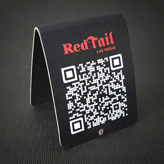 A black leather table tent with a QR code printed on the side, featuring the text 'Red Tail' and 'Las Vegas'.