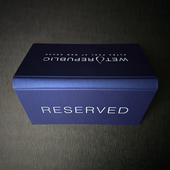 A metallic blue Vienna menu sign with 'RESERVED' text on the front, featuring a white debossed logo and design.