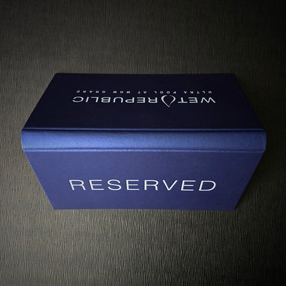 A metallic blue Vienna menu sign with 'RESERVED' text on the front, featuring a white debossed logo and design.