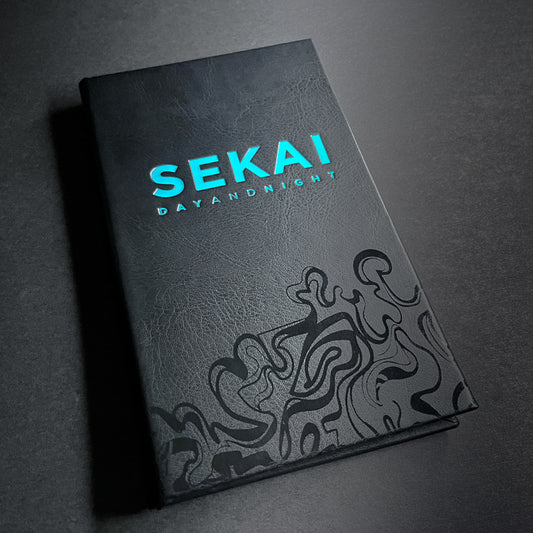 A closed black book with a blue logo and text on the cover, featuring a decorative pattern on the cover.