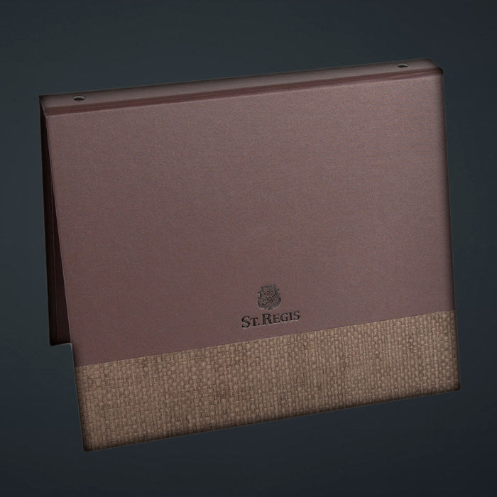 A brown St. Regis directory binder with French roast linen cover and matching basketweave design.