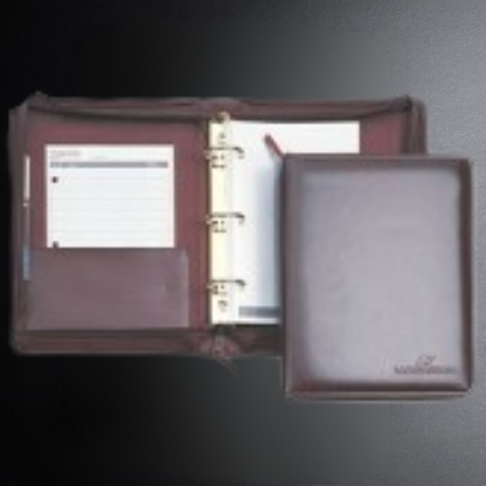 Brown leather binder with a gold ring on a dark background