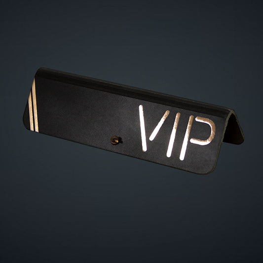 A black leather sign with the word 'VIP' in gold lettering.