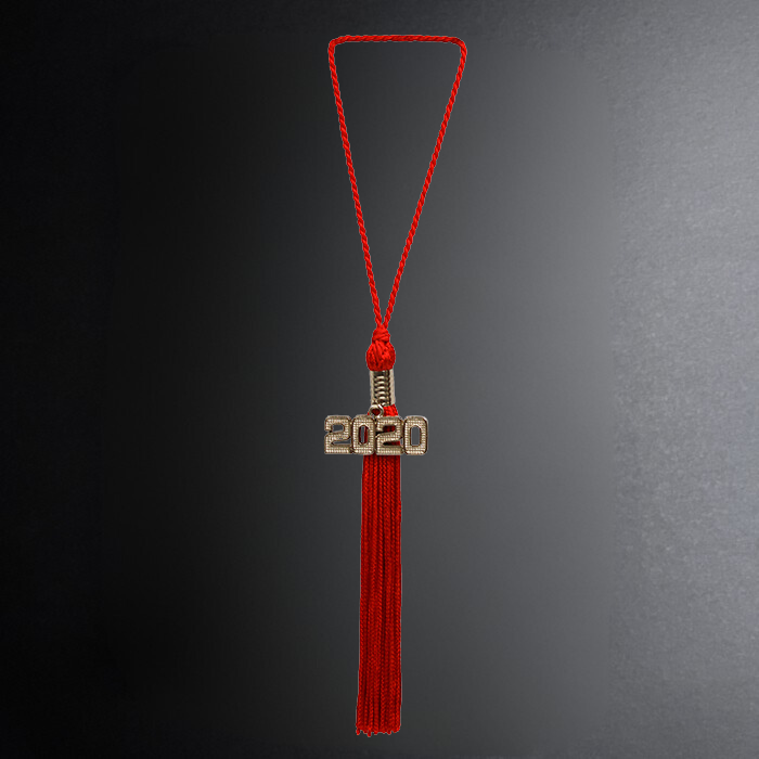 Red tassel with '2020' charm on a dark background