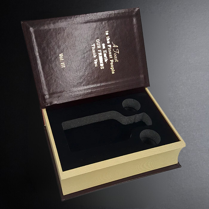 Brown leather-bound book with gold text on a dark gray background