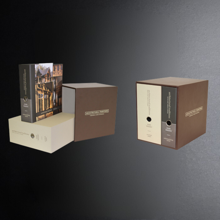 Two cardboard boxes with a book on a dark gray background