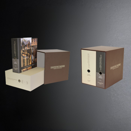 Two cardboard boxes with a book on a dark gray background