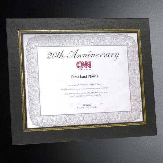 Framed certificate for CNN's 20th anniversary on a dark background