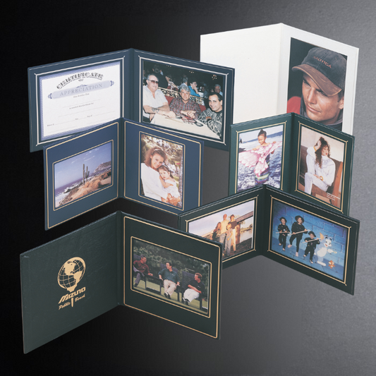 Memorabilia album with various photos and a certificate on a dark background