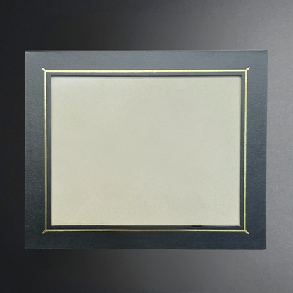 Dark gray picture frame with gold trim on a dark background